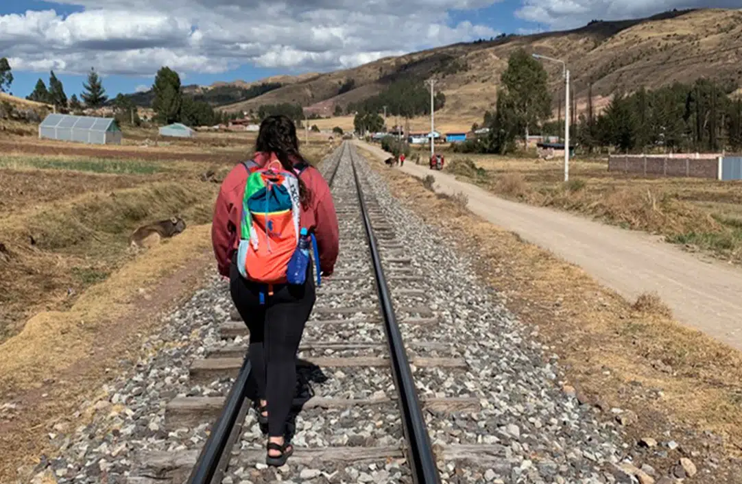Women walking down train tracks in Peru