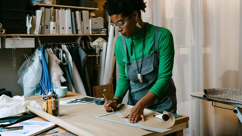 African American woman artist working at desk