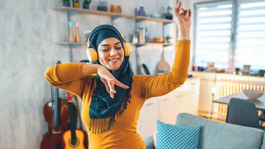 Woman dancing with headphones on her head
